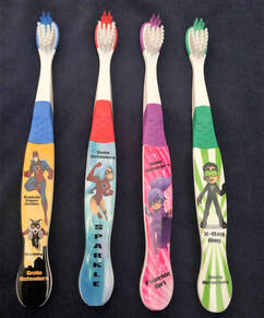 Picture of the custom Smile Defender Toothbrushes, showing all 4 designs.